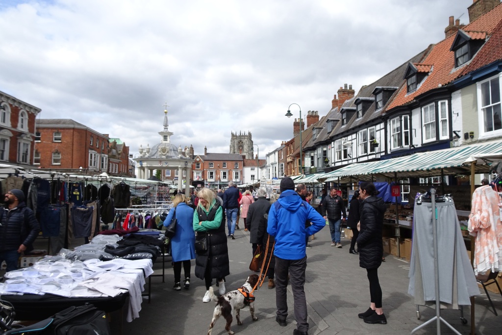 Saturday Market, Beverley, East Yorkshire, looking toward the Grade I listed Market Cross, with the Guest and Philips shopfront on the south side.